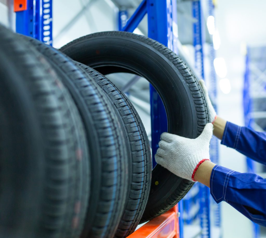 Mechanic taking a tyre from stock - Tyres North London